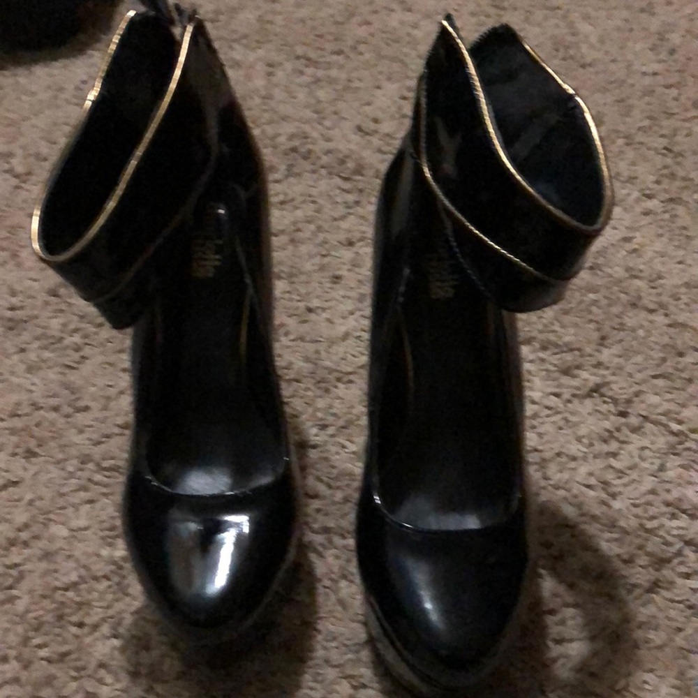 Black and gold ankle strap platform heels.